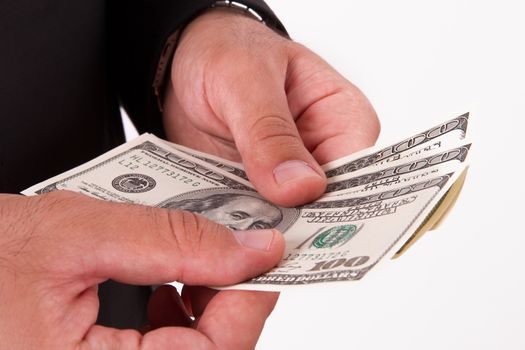 Businessman holding and counting money, hundred dollars, isolated on white background.