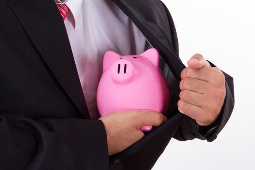 Pink piggy bank in safe with businessman in suit, isolated on white background.