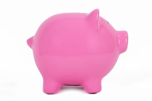 Pink piggy bank side view, isolated on white background.