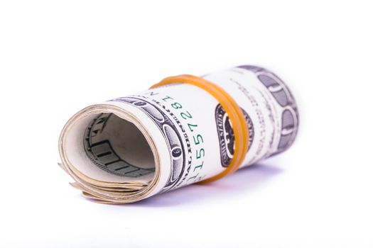 Roll of one hundred dollar banknotes, isolated on white background.