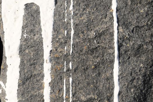 Texture Gray Rock Ancient Wall made of Volcanic Rocks and Dropping Paint