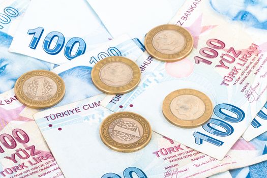 Close up view of one hundred Turkish lira banknotes with coins.