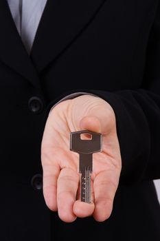 Young business woman holding and showing home key.