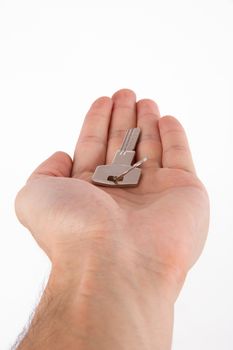 Giving door key in male human hand palm, isolated on white background.