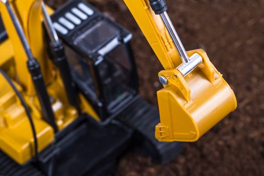 Construction machine, detail view of excavator on pile of soil.