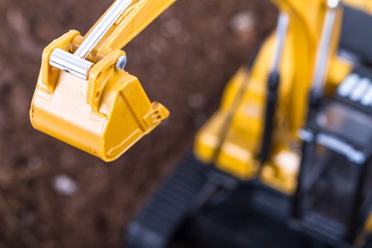 Construction machine, detail view of excavator on pile of soil.