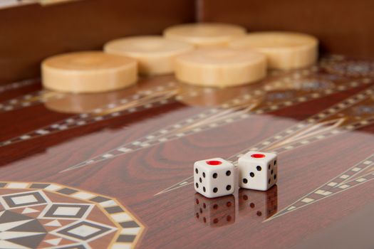 Backgammon table, chips and dice with double one.