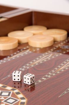 Backgammon table, chips and dices with double six.