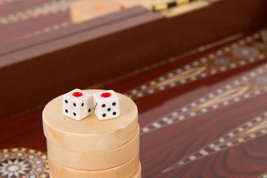Backgammon table, chips and dices with double one.