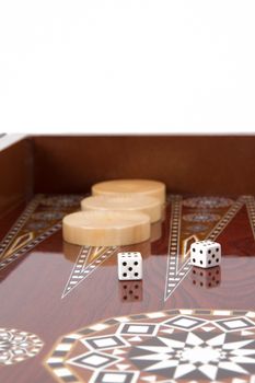 Backgammon table, chips and dice with double six.