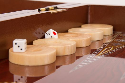 Chips and dices on backgammon table.