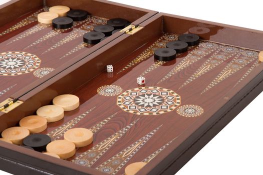 Backgammon table, chips and dices with double five during the game, isolated on white background.