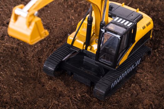 Construction machine, detail view of excavator on pile of soil.