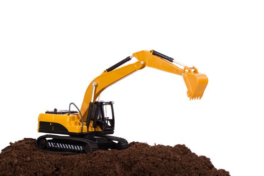 Construction machine, excavator on pile of soil, isolated on white background.