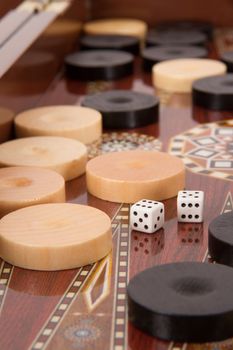 Complicated backgammon chips and dices with six and five.