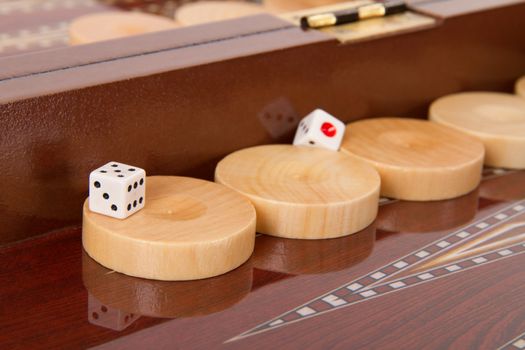 Chips and dices on backgammon table.