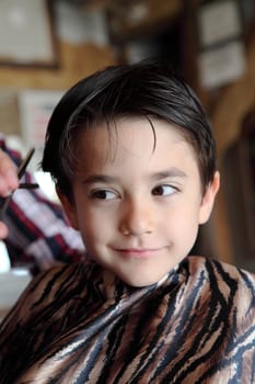 Male child at the barber shop to cut the hair