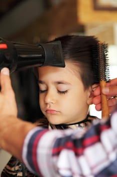 Male child at the barber shop to cut the hair