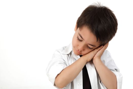 Young boy in studio acting sleeping