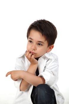 Young boy in studio holding his chin