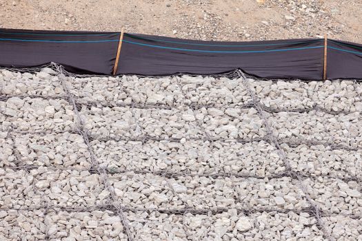 Gravel and wire mesh used in bank revetment to control river bank erosion protection