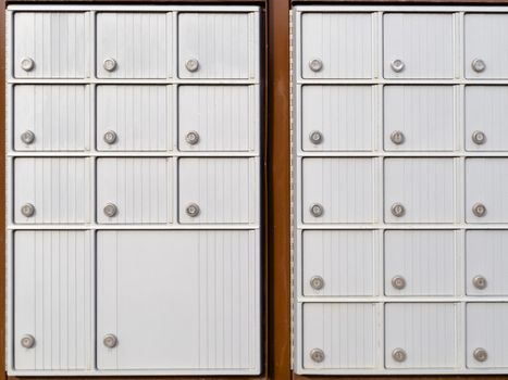 Pattern of rows of lockers with metal doors and locks of outdoor silver canadian mailboxes for safe delivery of rural mail post