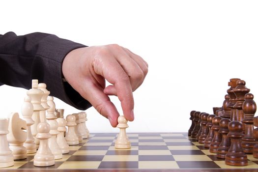 Businessman playing chess and holding pawn, isolated on white background.