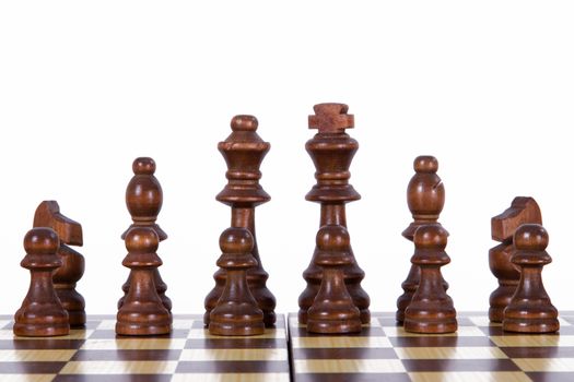 Dark brown chess pieces on board, isolated on white background.