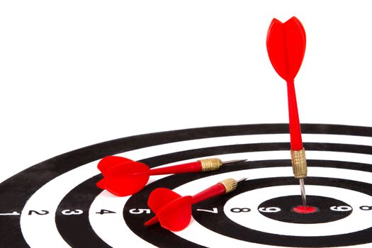 Red arrow and dart board, isolated on white background.