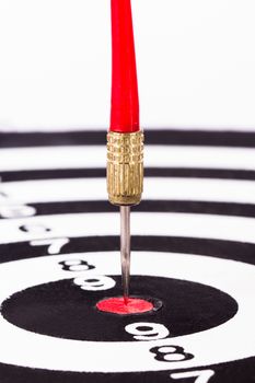 Arrow in the middle of dart board, isolated on white background.