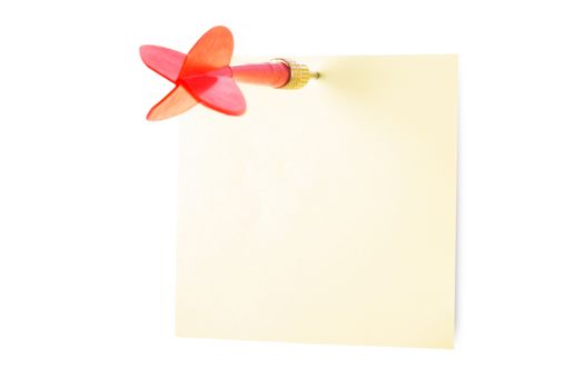 Red, plastic dart arrow and yellow sticky post it note, isolated on white background.