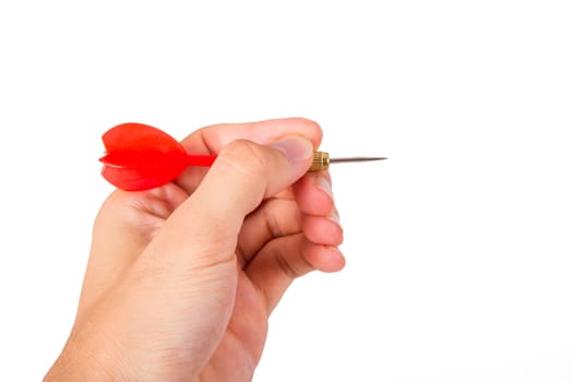 Hand holding red, plastic dart arrow, isolated on white background.