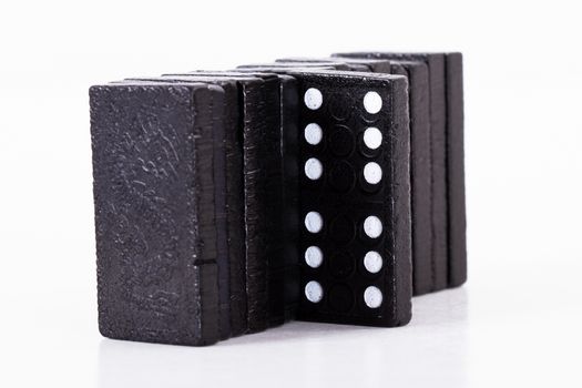Leadership concept, domino standing out from the crowd, isolated on white background.