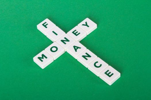 Finance and money words in letters on green background.