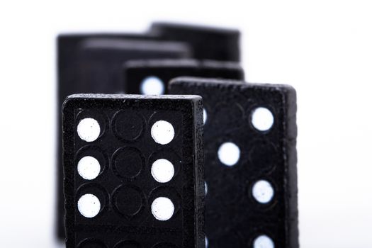 Dominoes pieces in a row, isolated on white background.