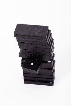 Black dominoes in a row, isolated on white background.