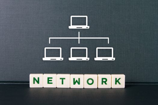 Network word in letters and laptop icons which are interconnected to each other.