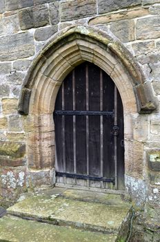 Ancient wooden door on a fourteenth century church in the County of Sussex, England.