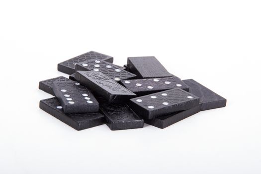 Stack of black dominoes, isolated on white background.