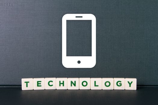 Technology word in letters with sketch of mobile phone.