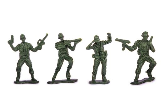 Group of miniature toy soldiers, isolated on white background.