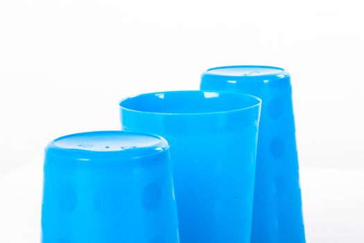 Thimblerig with three plastic glasses, isolated on white background.