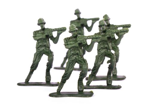 Group of attackers, miniature toy soldiers, isolated on white background.