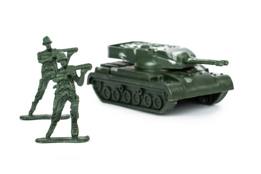 Miniature toy tank and attacker soldiers, isolated on white background.