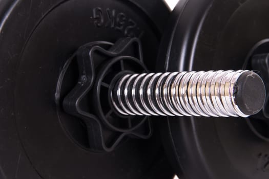 Close up view of single black gym barbell, dumbbell, isolated on white background.