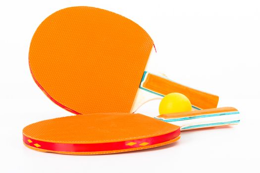 Table tennis rackets and ball, isolated on white background.