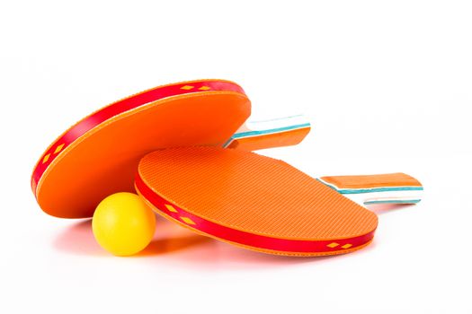 Orange ping pong rackets and ball, isolated on white background.
