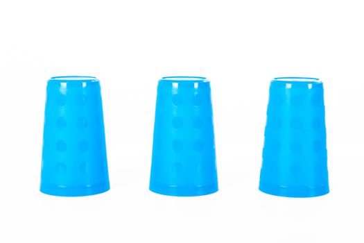 Thimblerig with three plastic glasses, isolated on white background.