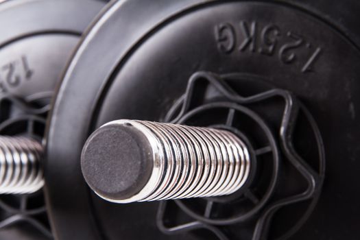 Black gym barbell, dumbbell with disks.