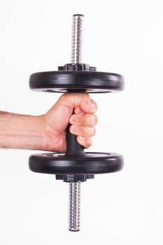 Hand holding black gym barbell, dumbbell with disks, isolated on white background.
